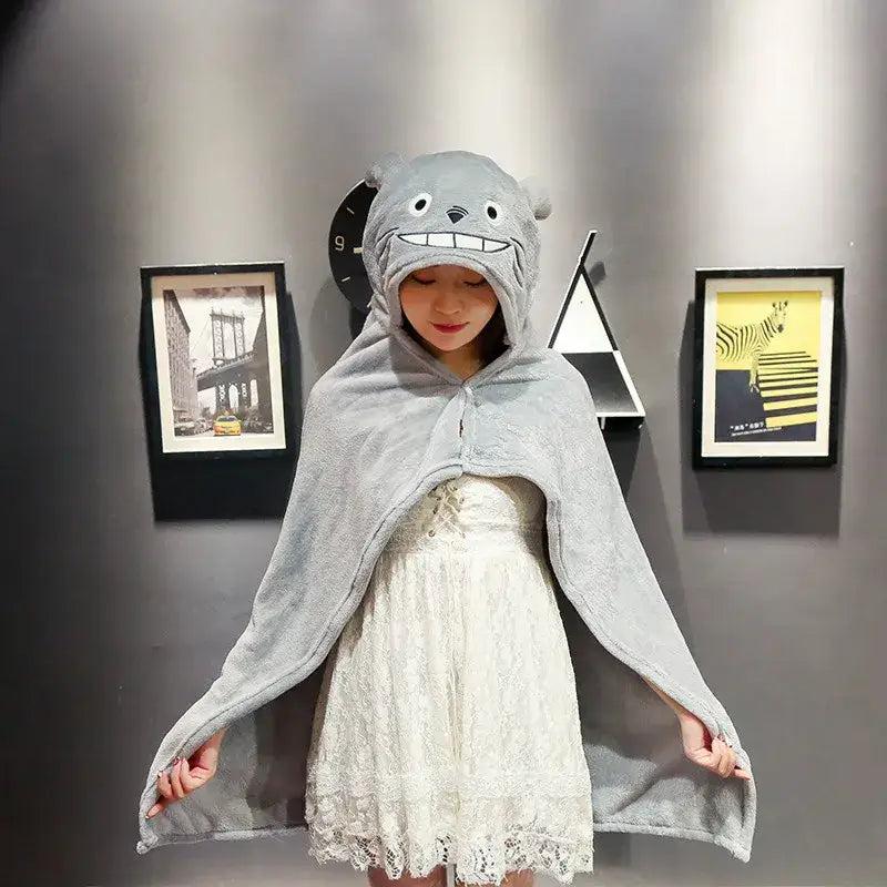 Gray totoro-themed plush hooded cape blanket with soft fuzzy texture and embroidered facial features for warmth in bedroom and office