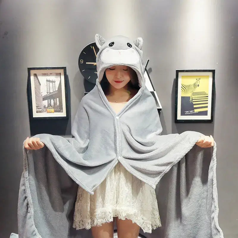 Gray plush hippo hooded cape blanket with soft textured fabric and embroidered facial features for bedroom and office warmth