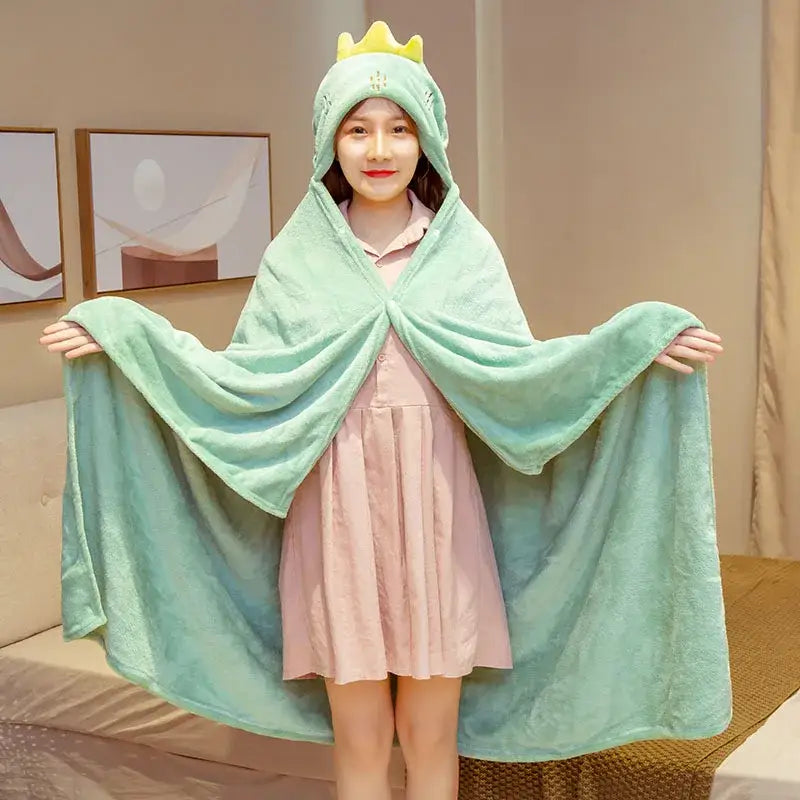 Mint green plush dinosaur hooded cape blanket with yellow crown detail for bedroom and office warmth
