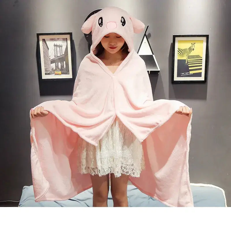 Pink plush pig-themed hooded cape blanket with soft fluffy texture and embroidered face for bedroom and office warmth