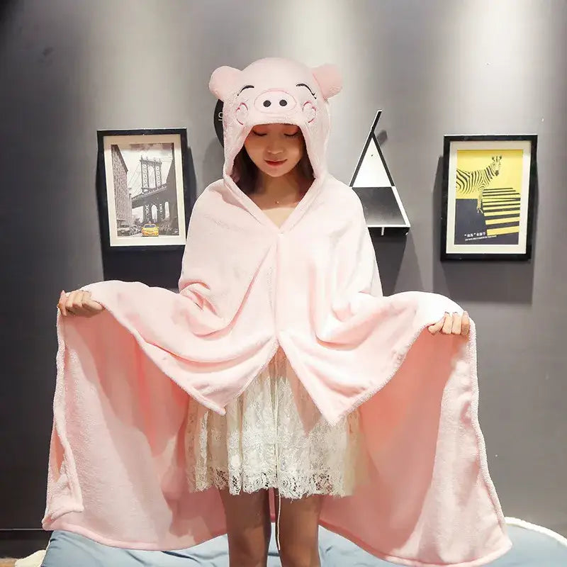 Pink plush pig-themed hooded cape blanket with soft fluffy texture and embroidered face for bedroom and office warmth