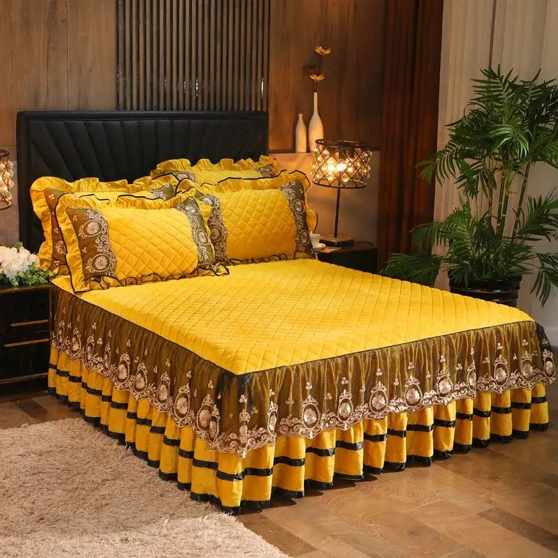 Yellow quilted bed skirt with gold and black decorative trim and ruffled edges from decorbites crystal velvet bedspread set