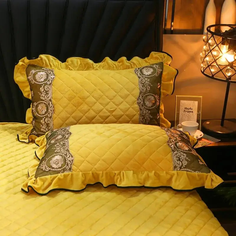 Yellow quilted pillowcases with ruffled edges and ornate gray panels in decorbites crystal velvet bedspread set
