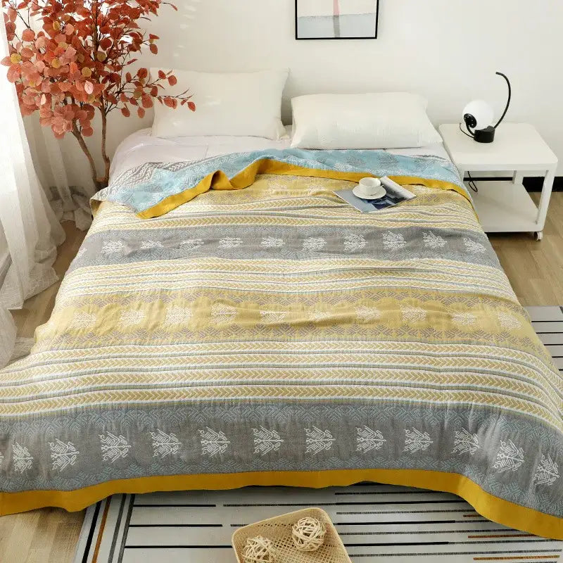 Cozy yellow and gray cotton stripe gauze towel quilt with white botanical patterns and mustard-yellow border for summer use
