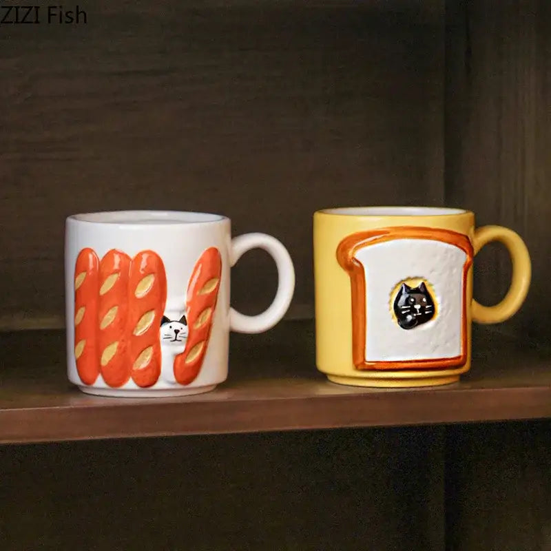 Two ceramic mugs featuring bread pattern ceramic designs with a white peeking cat and yellow toast cup illustration