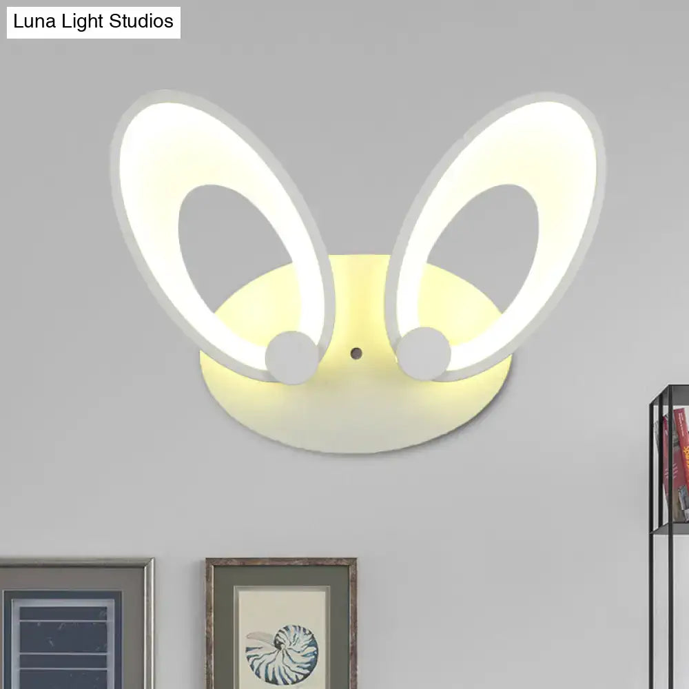 A modern yellow bunny led ceiling light with white finish glowing oval ears for bedroom decor