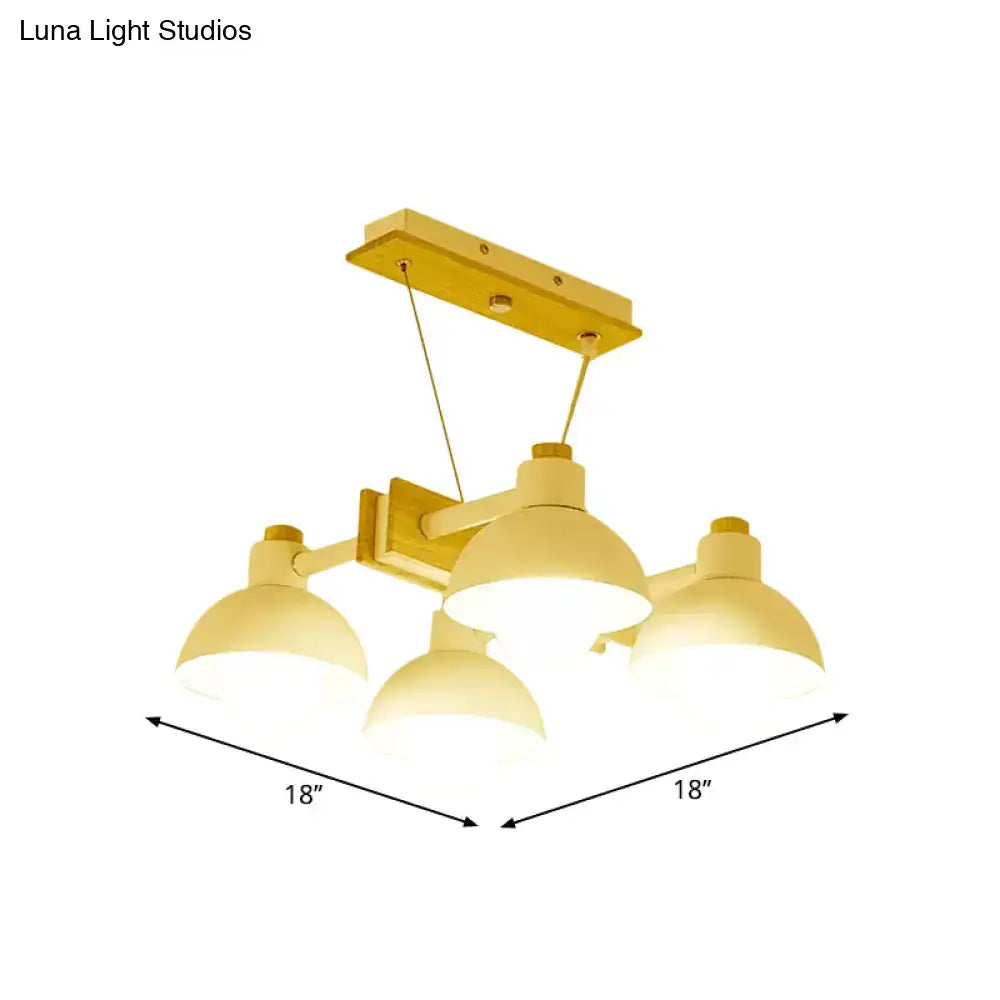 Yellow metal dome shade linear chandelier with three dome-shaped light fixtures and adjustable chain cord length