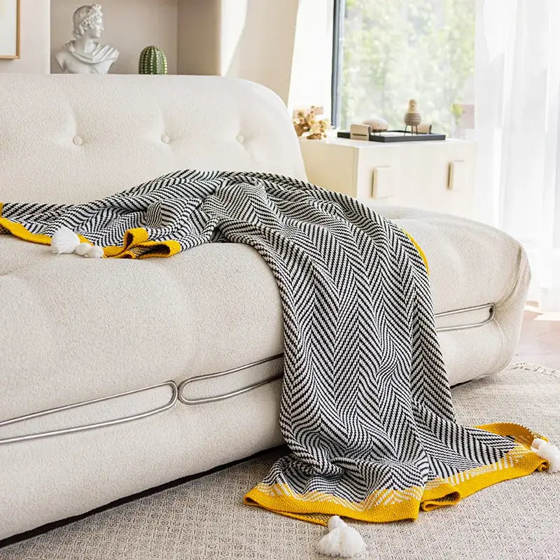 Black and yellow herringbone knit diagonal stripe sofa blanket with white pom-poms for living room decorbites knitted diagonal