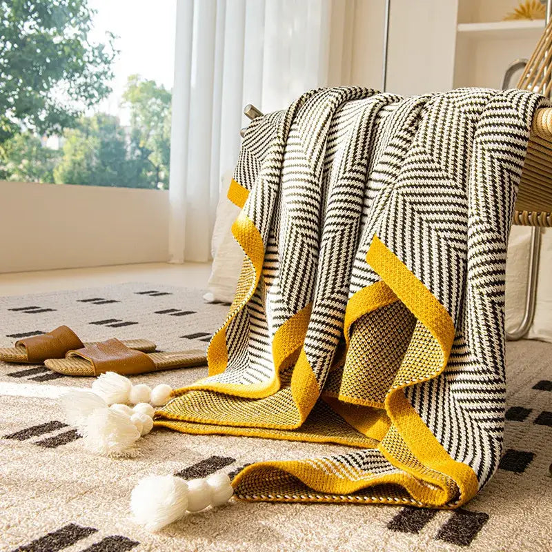 Cozy sofa blanket with black and white diagonal stripe pattern yellow edge and fluffy tassels perfect for decorbites knitted diagonal decor