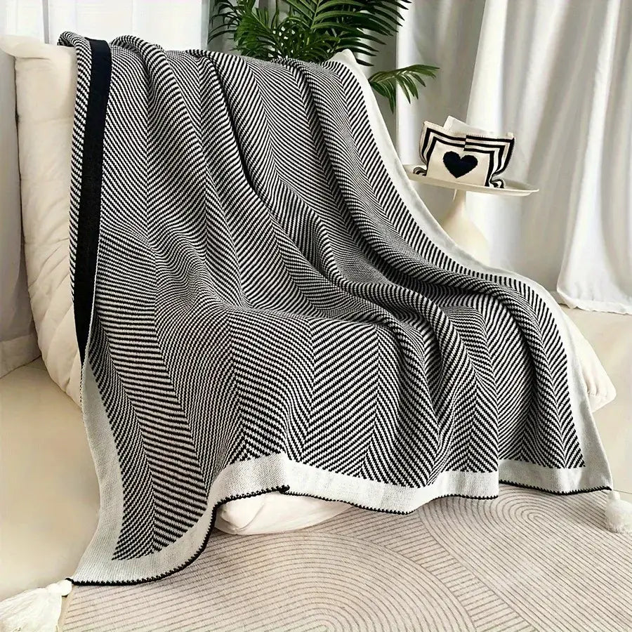 Black and white herringbone knit sofa blanket with yellow edge and diagonal stripe decorbites knitted diagonal design
