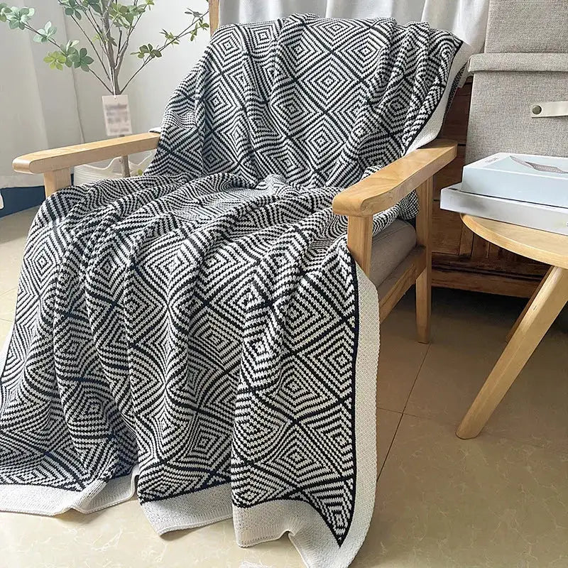 Black and white geometric patterned knitted diagonal stripe sofa blanket with yellow edge for living room decorbites