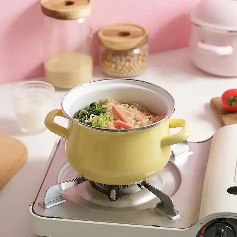 Yellow enamel cooking pot with two handles filled with noodles and vegetables enamel stock pot for kitchen use