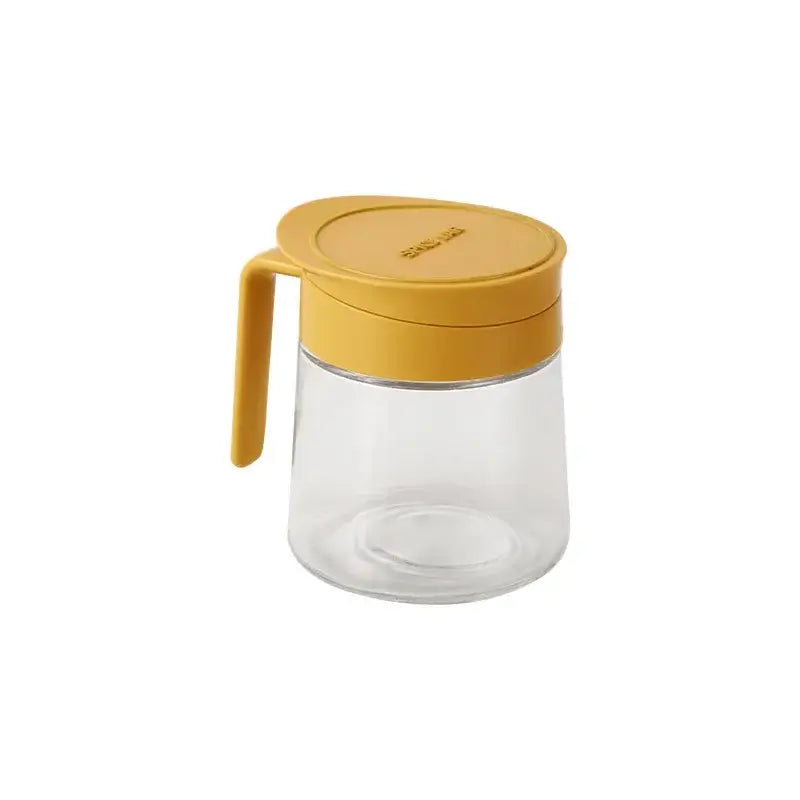 Yellow flip top glass seasoning jar with spoon featuring clear glass body and mustard-yellow lid embossed with sunny brand name