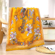 Vibrant yellow cotton large bath towel with detailed floral and bird pattern and ornate borders for bathroom decor