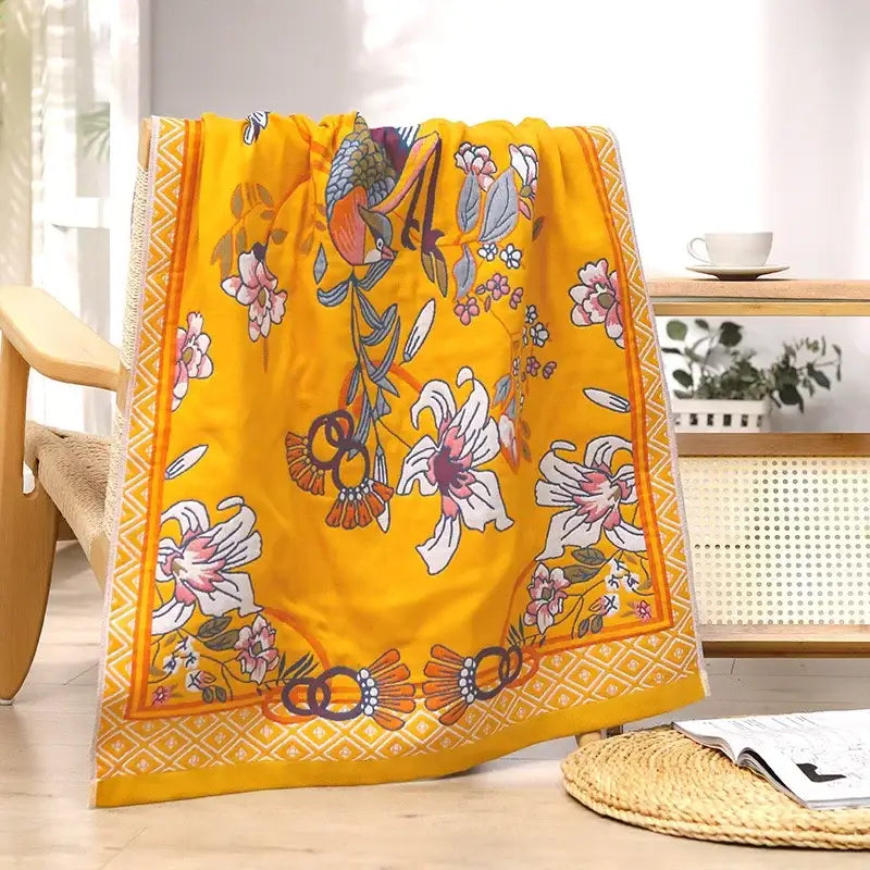 Vibrant yellow cotton large bath towel with detailed floral and bird pattern and ornate borders for bathroom decor