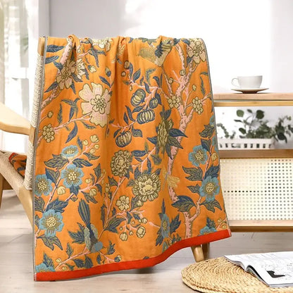 Vibrant orange cotton large bath towel with intricate blue green cream floral pattern for bathroom decor