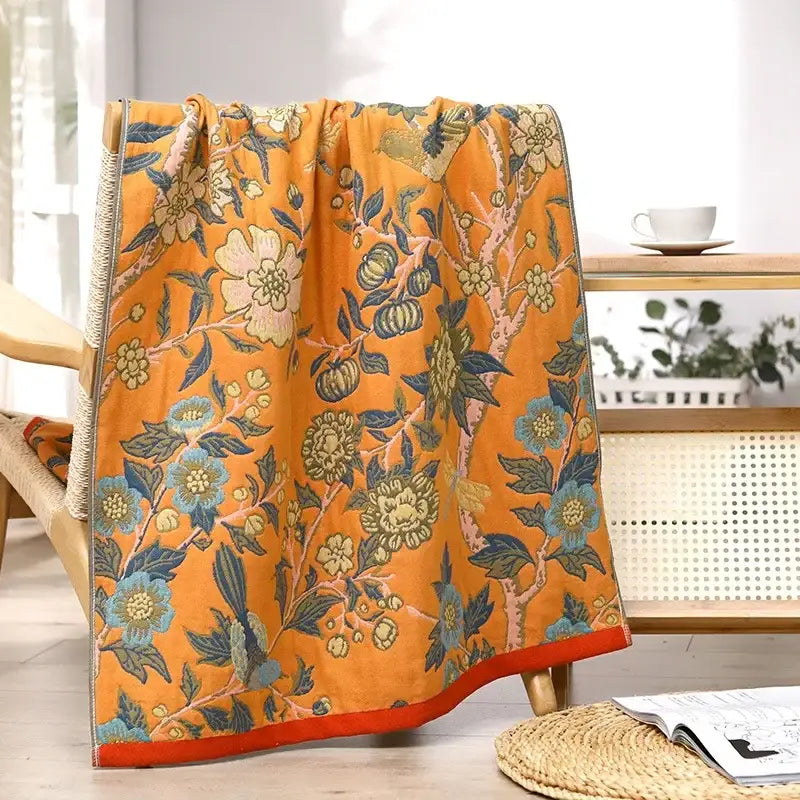 Vibrant orange cotton large bath towel with intricate blue green cream floral pattern for bathroom decor