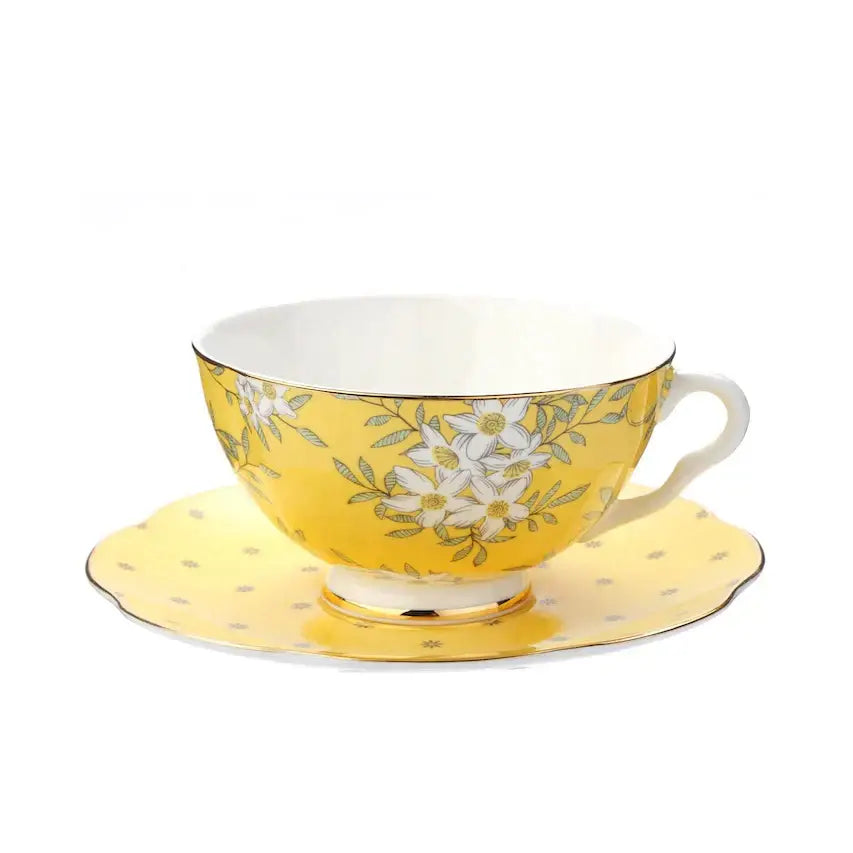 Yellow porcelain lemon tree bone china teacup with white floral pattern and gold trim with matching saucer decorbites lemon tree