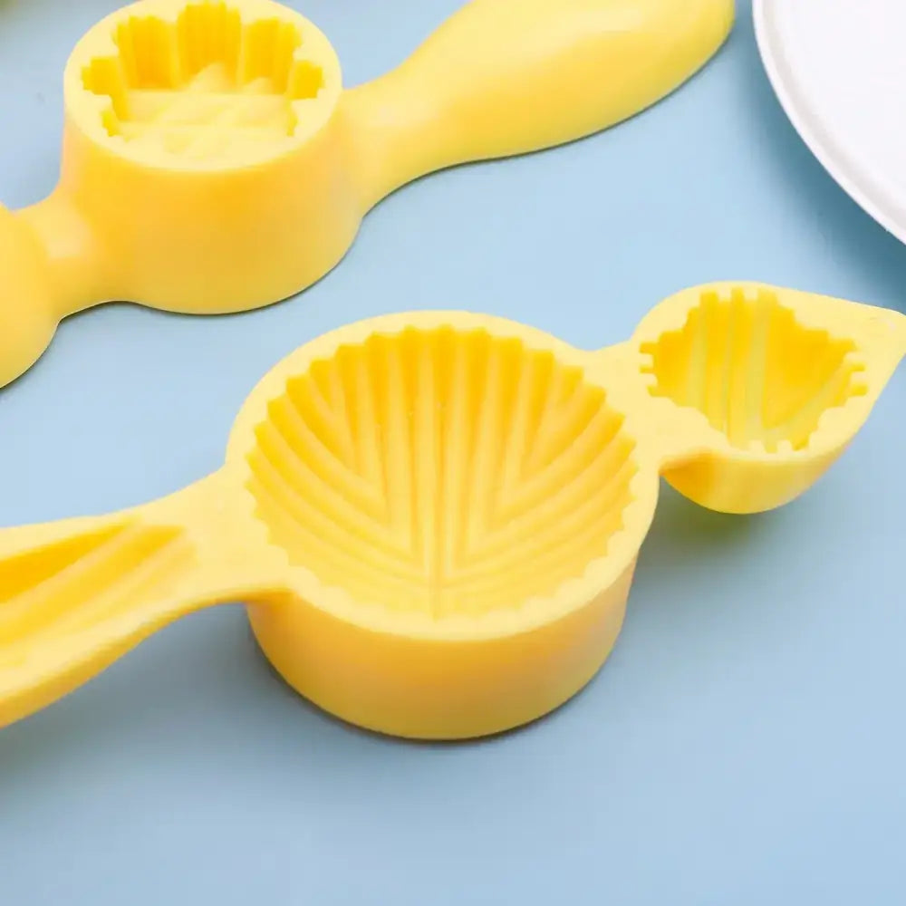Bright yellow silicone shell shaped cookie press with detailed ridged interior for decorbites biscuit cake date pistachio molding