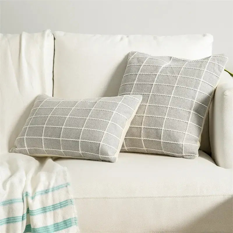 Gray throw pillows with white embroidered grid patterns on cream sofa featuring decorbites cotton woven check cushion cover