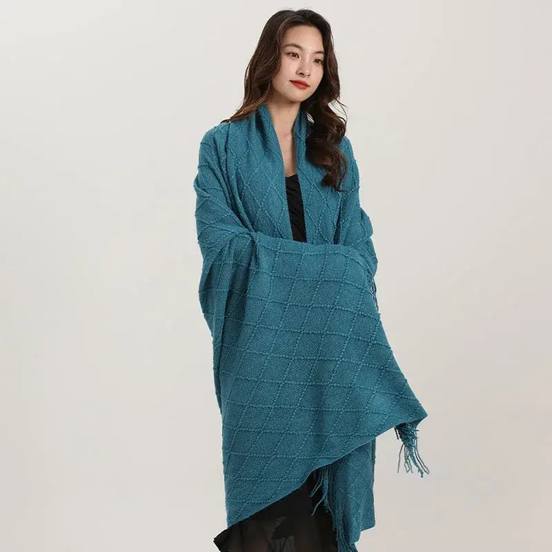 Teal decorbites knitted diamond wrap with fringed edges and diamond pattern used as a bedroom shawl or blanket