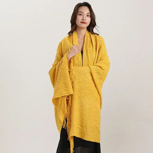 A vibrant yellow decorbites knitted diamond blanket with fringed edges ideal for bedroom decor or shawl wrap