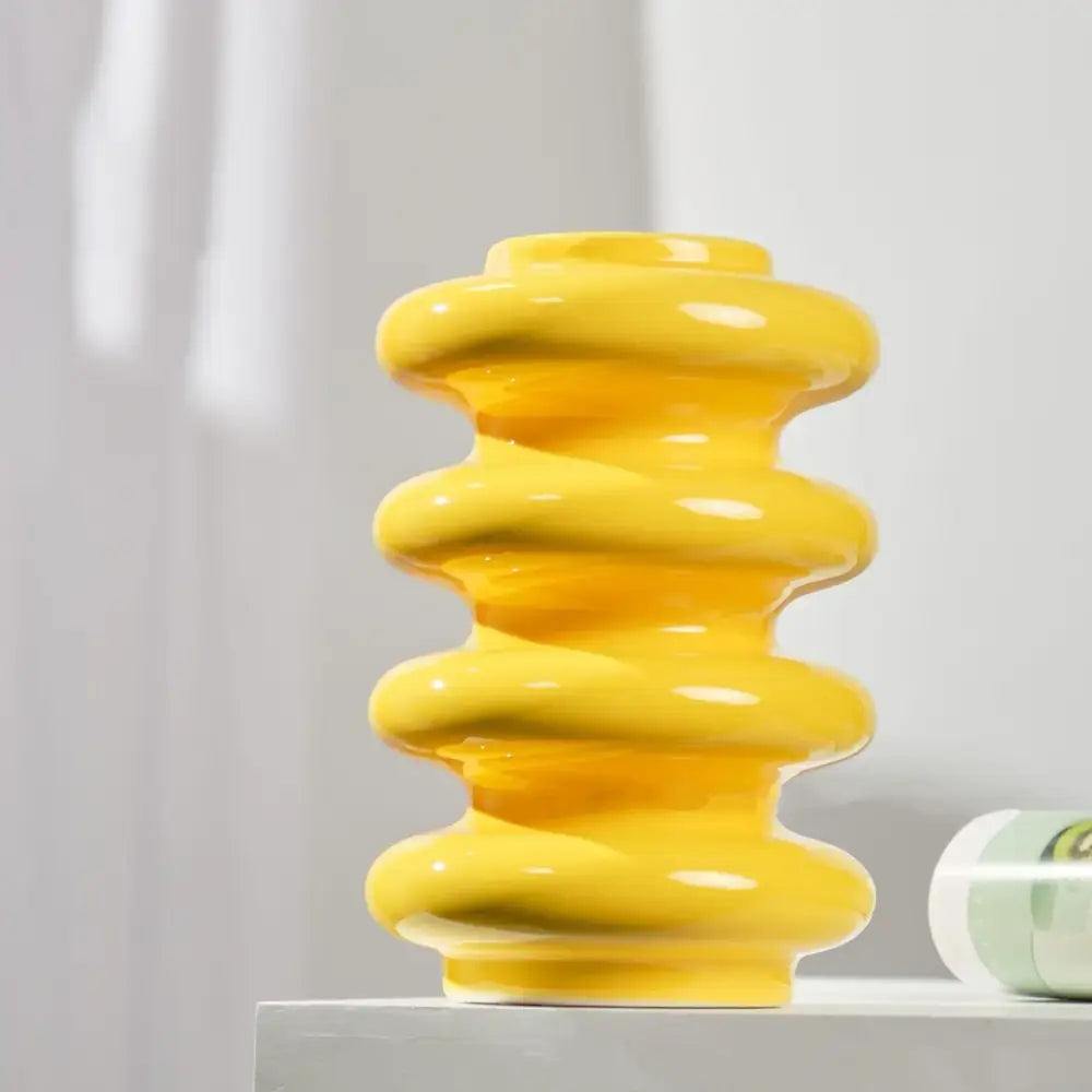 A vibrant yellow ceramic vase with a stacked spiral design perfect for living room decorbites geometric circles abstract decor