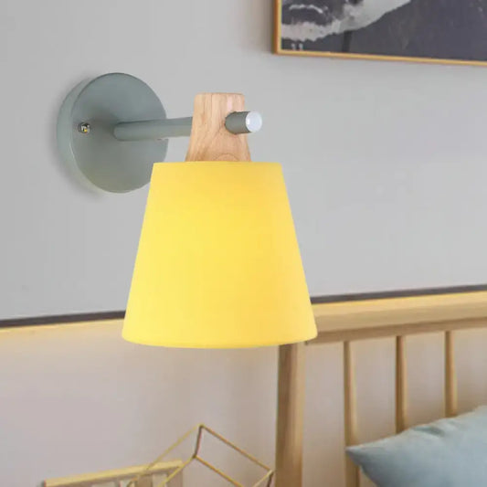 Yellow macaron fabric wall light with e26 e27 socket mounted on gray metal arm with natural wood accent bedroom sconce