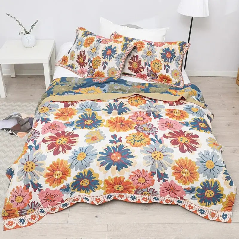 Vibrant floral-patterned decorbites cotton gauze soft throw blanket with colorful daisies and lace trim on cream background