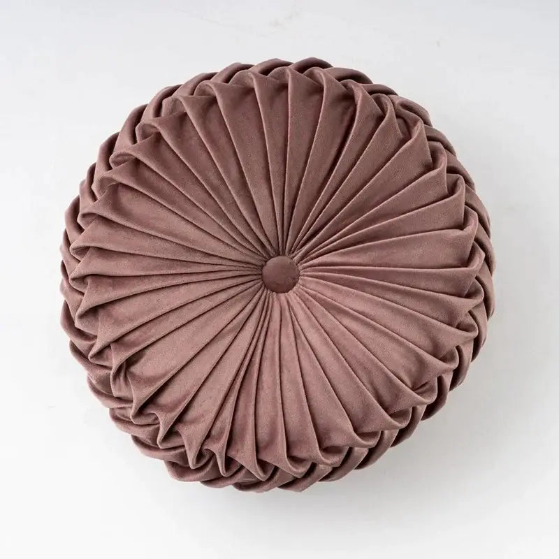 A mauve velvet round throw pillow with radial pleated design and central button for living room decorbites 3d pumpkin style