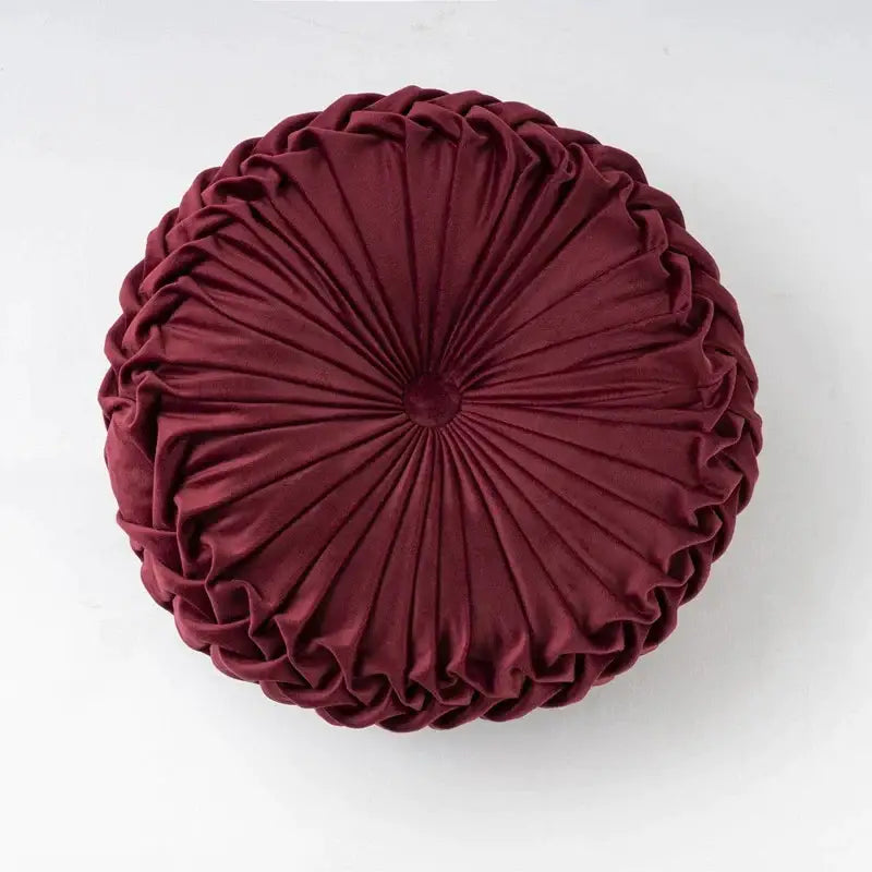 A plush deep burgundy velvet round throw pillow with a gathered pleated design for living room decorbites 3d pumpkin decor