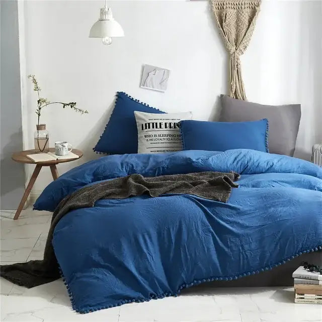 Blue quilted duvet cover with pom-pom trim from decorbites furball tasseles bedding set for stylish bedroom decor