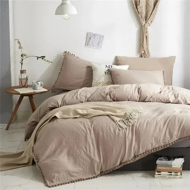 Beige textured duvet set with pom-pom trim and matching pillows from decorbites furball tasseles bedding set collection