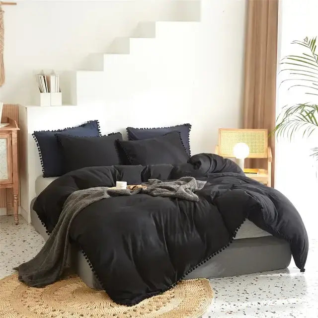 Black plush comforter with pom pom trim from decorbites furball tasseles bedding set for bedroom use