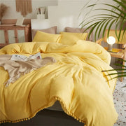 Bright yellow quilted bedding set with pom-pom trim from decorbites furball tasseles furball tasseles bedding