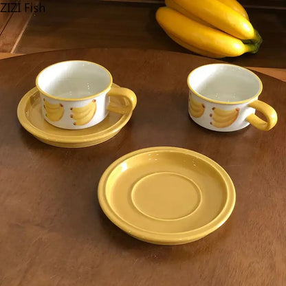 Yellow ceramic banana-themed teacups with matching saucers in a decorbites fruits pattern porcelain coffee mug set