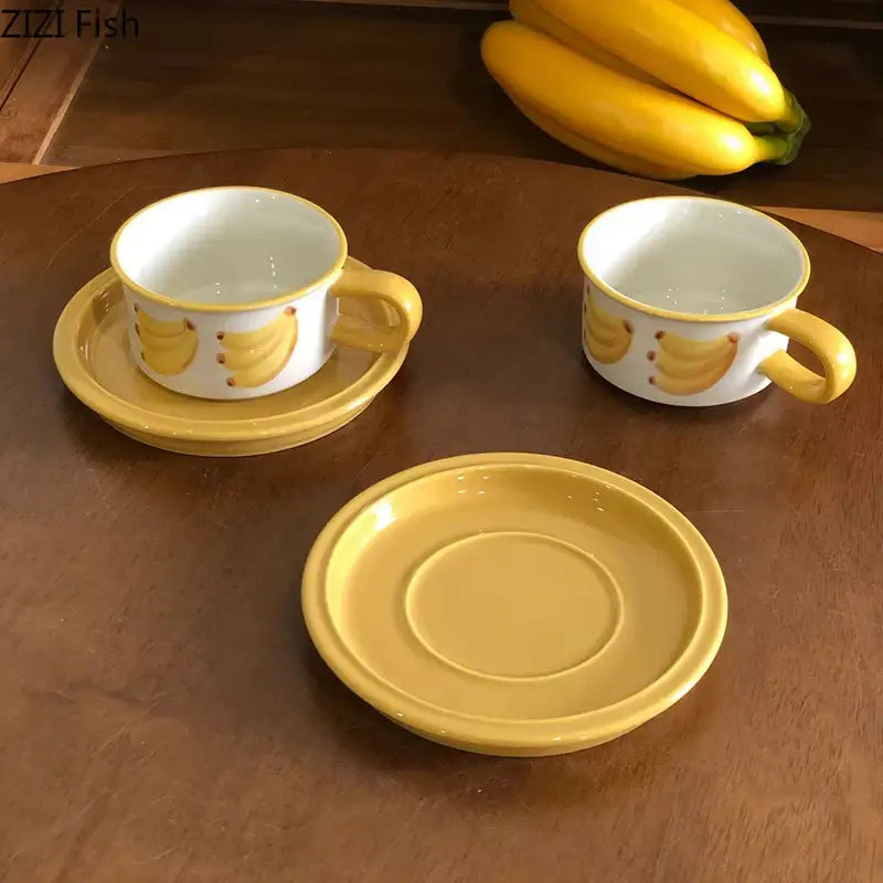 Yellow ceramic banana-themed teacups with matching saucers in a decorbites fruits pattern porcelain coffee mug set