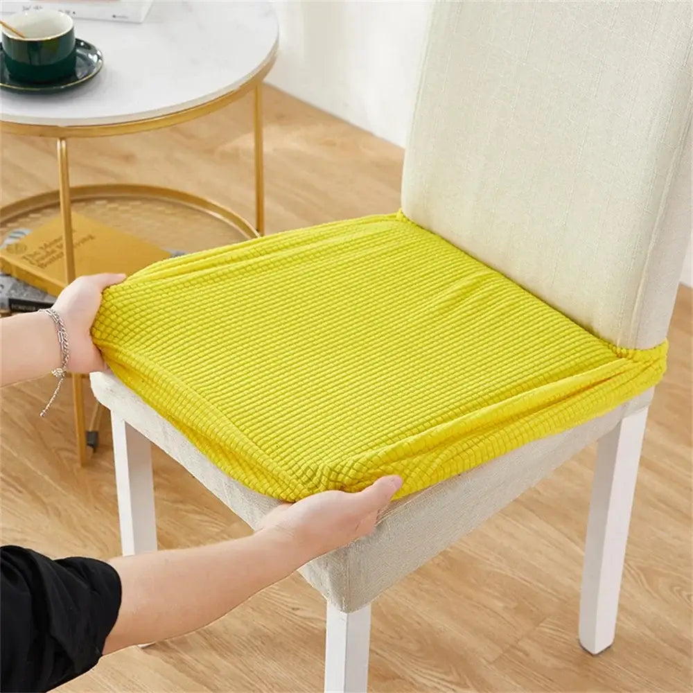 Bright yellow ribbed fleece chair cover designed as a chair pad for dining room seat protection