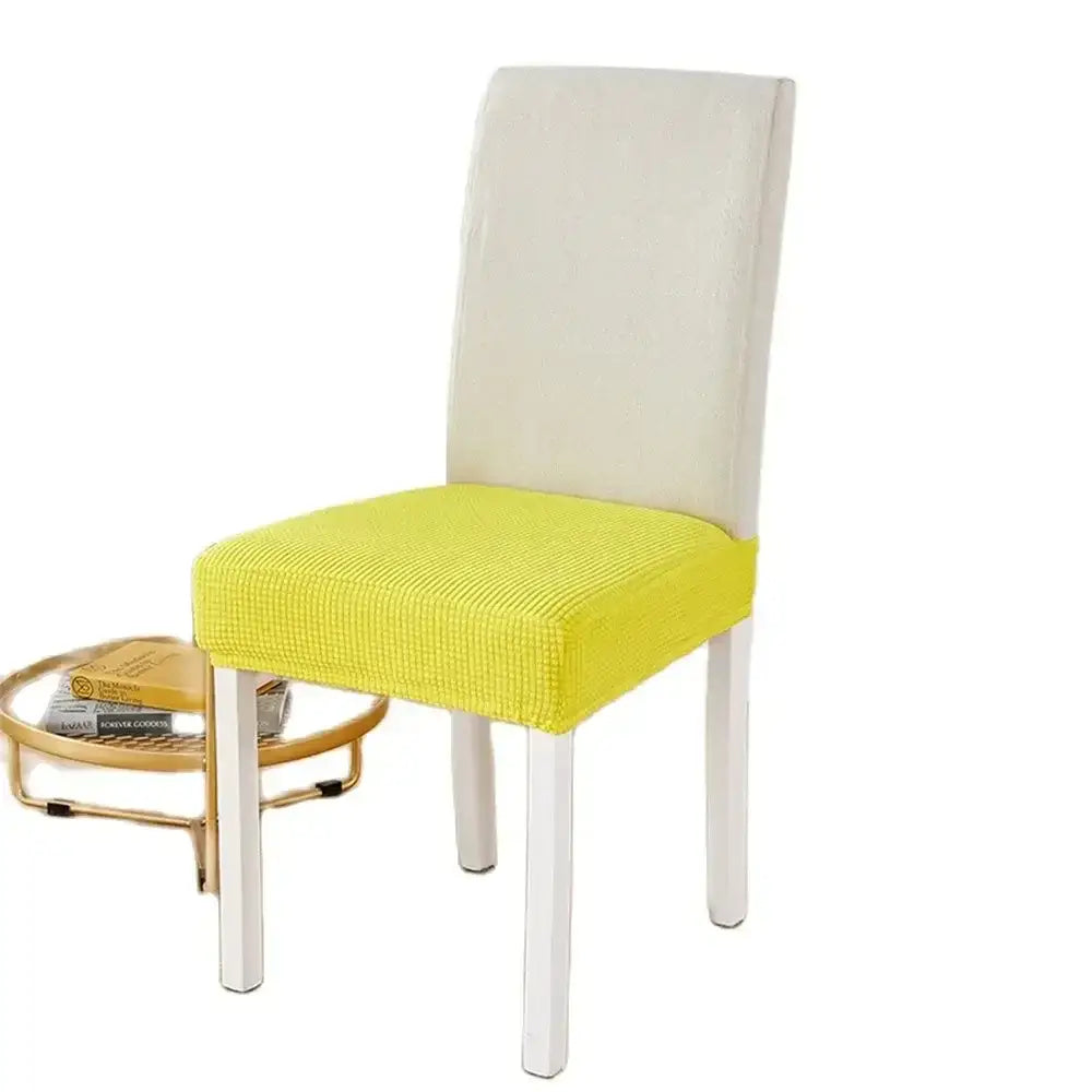 Bright yellow ribbed fleece chair cover snugly fits white dining chair for seat protection and style
