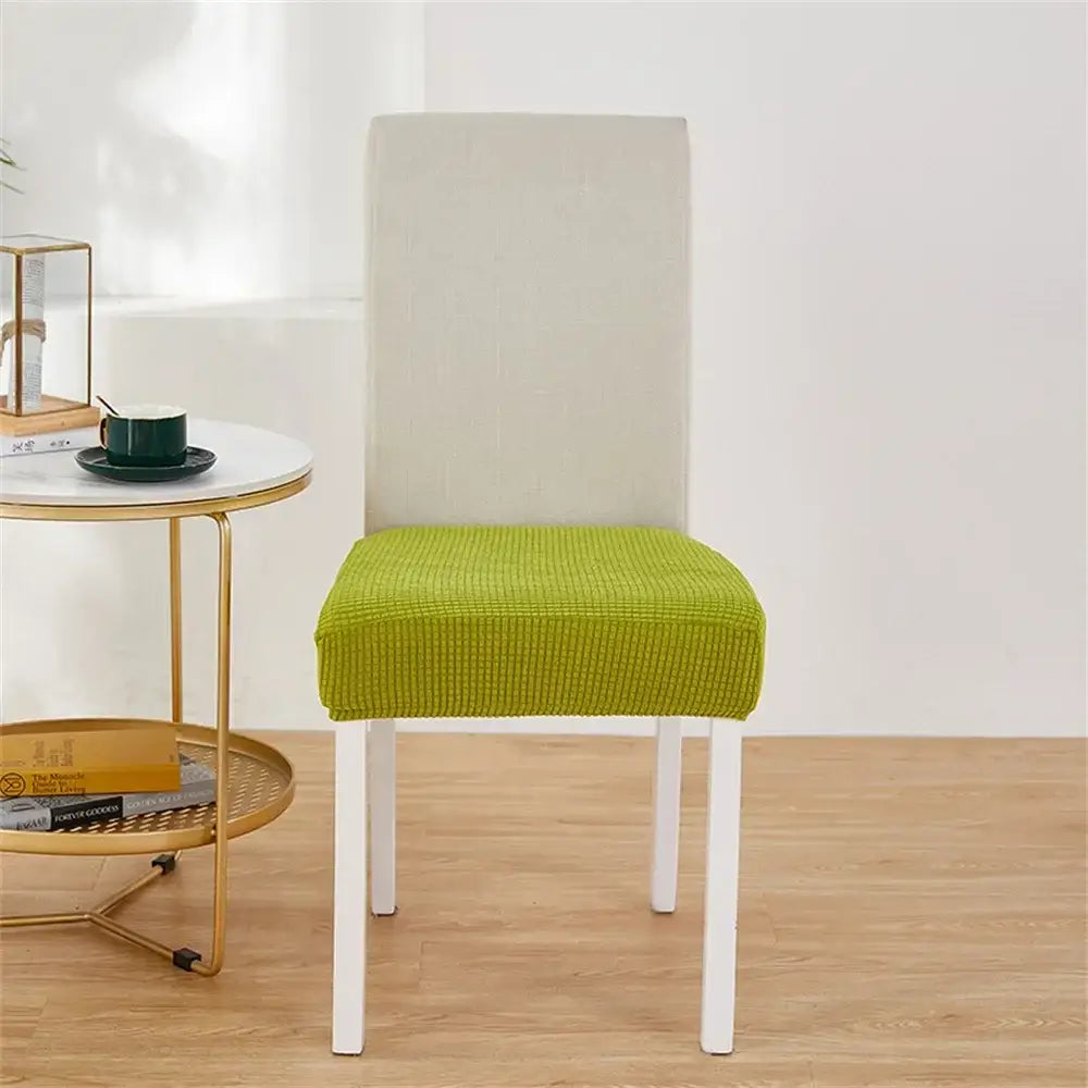 Bright lime green ribbed fleece chair cover snugly fits over a modern white dining chair for seat protection