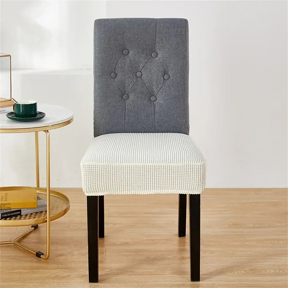 Gray tufted chair with white textured seat cover featuring a yellow ribbed fleece chair cover for seat protection