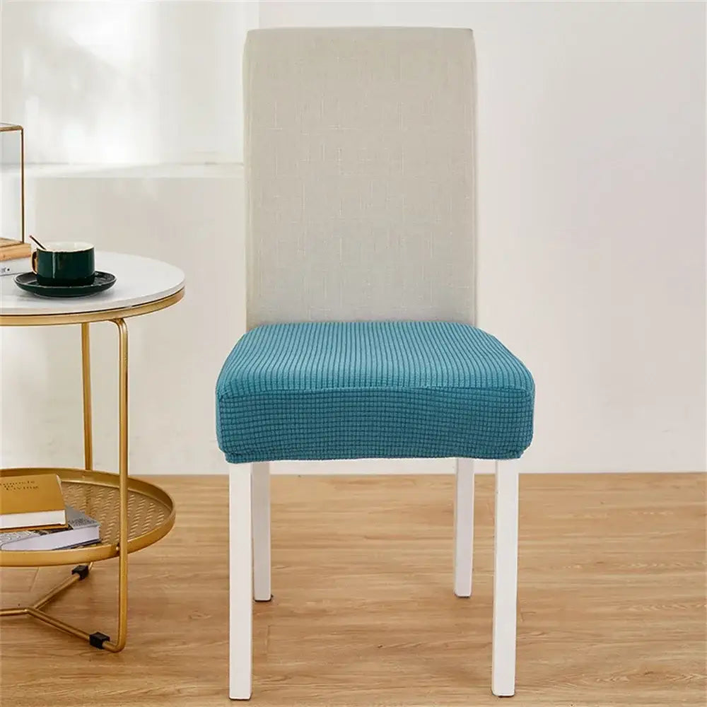 Teal fleece chair cover with ribbed texture and contrasting light gray backrest for dining room seat protection