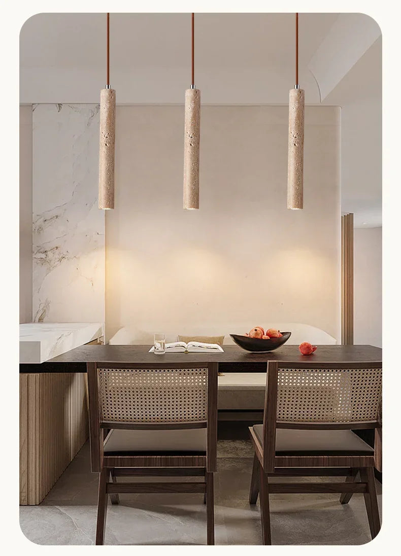 Three beige textured concrete stone pendant lights hang from the ceiling in a bedroom setting for ambient lighting