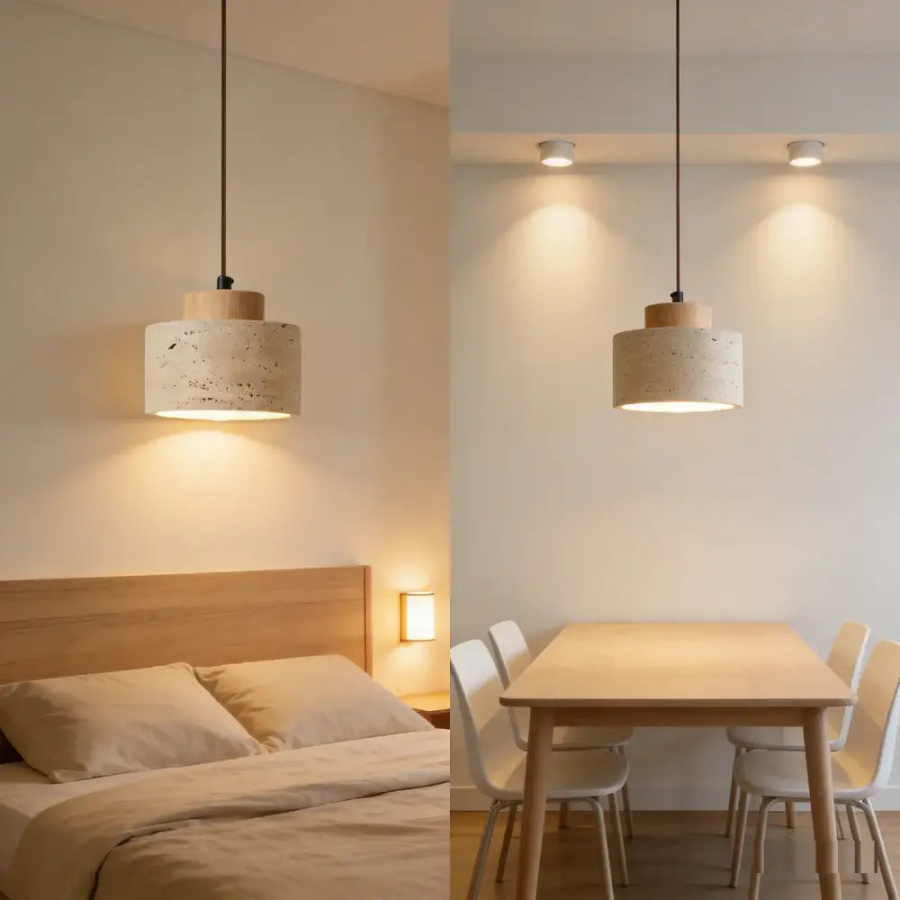 Two cylindrical pendant lights with yellow travertine stone shades and wooden tops hang from black cords for kitchen use