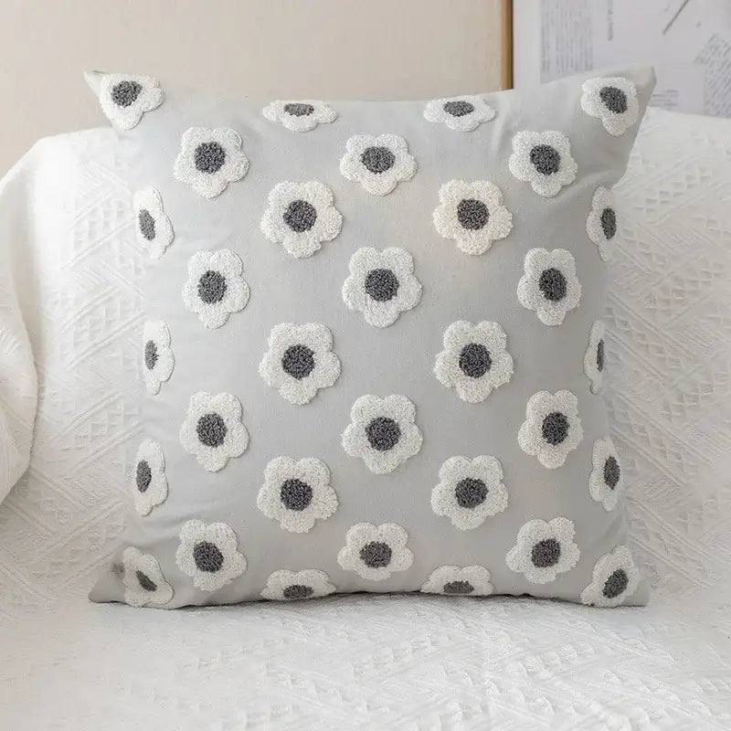 Light gray pillow cover with raised white and dark gray embroidered flora cotton design for bedroom sham