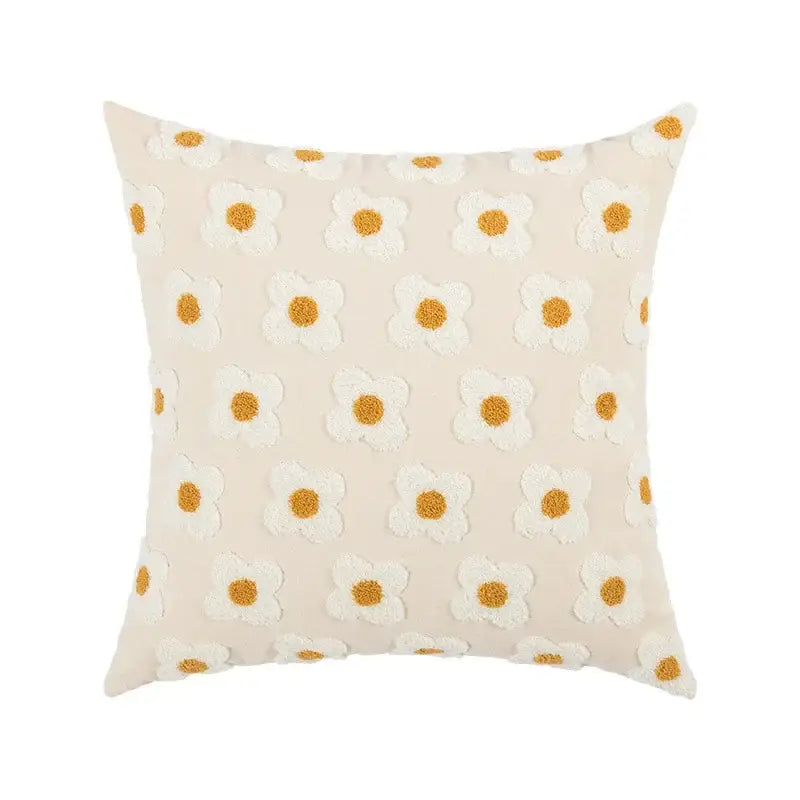 Beige cotton pillow cover with embroidered flora featuring white daisies and golden-yellow centers for bedroom use