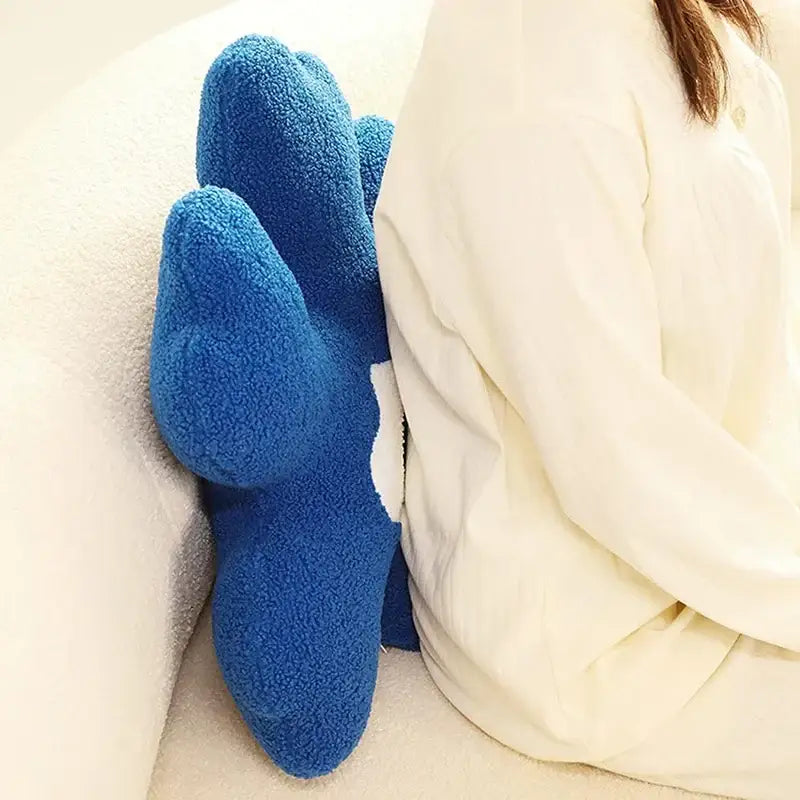 Blue plush dinosaur shaped footrest complementing yellow and white flower shaped decorative throw pillow decorbites 3d flower decor