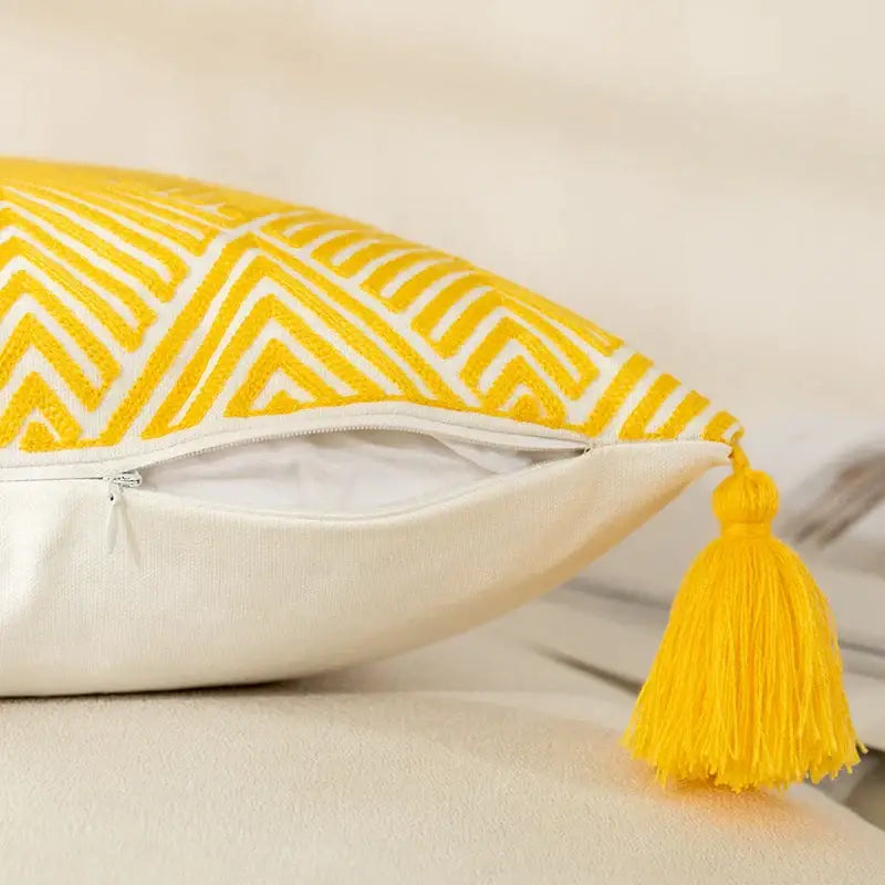 Yellow and white geometric embroidery canvas cushion cover with yellow geometric pattern and matching tassel accent for decorbites decor