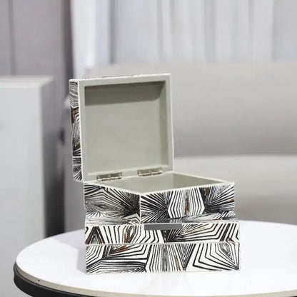 Zebra black and white jewelry storage box with modern geometric pattern metallic hinges and silver interior linings for desktop organization
