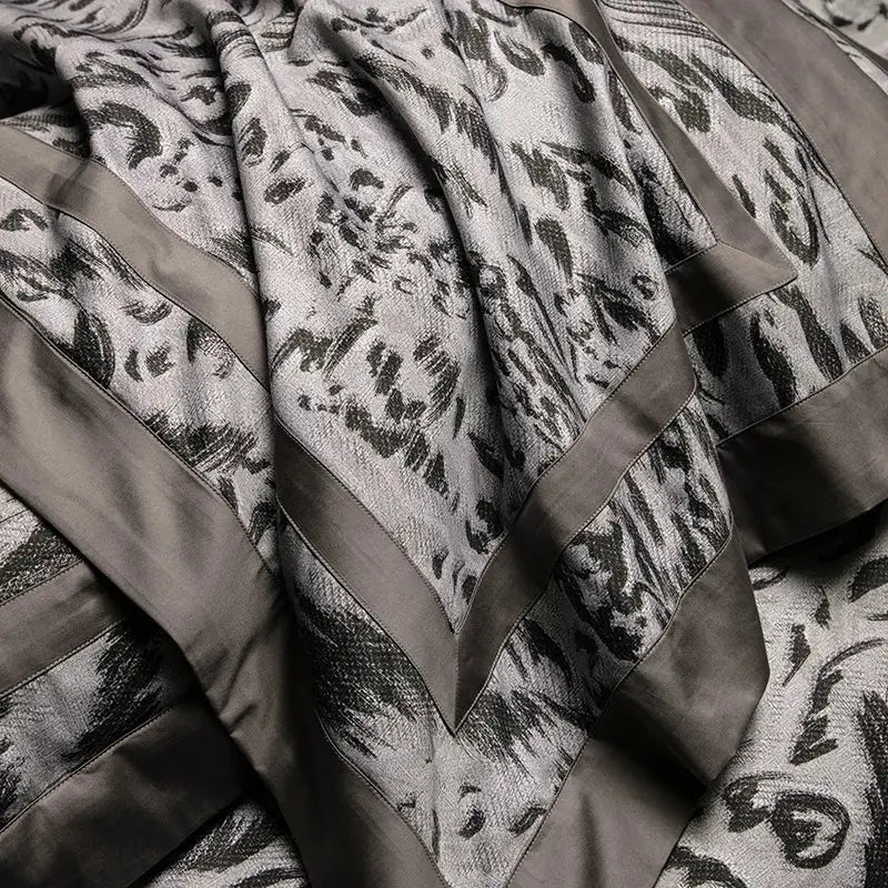 A luxurious gray and black patterned throw blanket with bold abstract floral motifs in decorbites 1000tc egyptian cotton bedding set